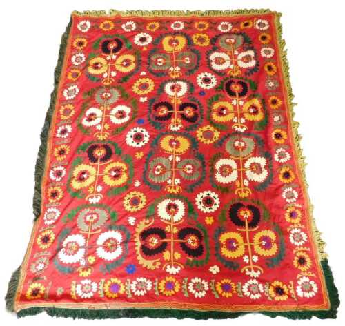 An Uzbek Suzani, decorated with flowers, etc., in shades of gold, green, white, navy, gold, on a...