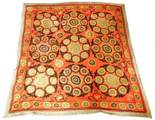 An Uzbek Suzani, decorated with roundels in green, gold and navy, within black scrollwork, on a...
