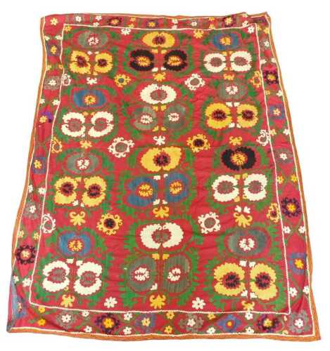 An Uzbek Suzani, decorated with flowers in white, blue, silver, gold, within outer borders of...