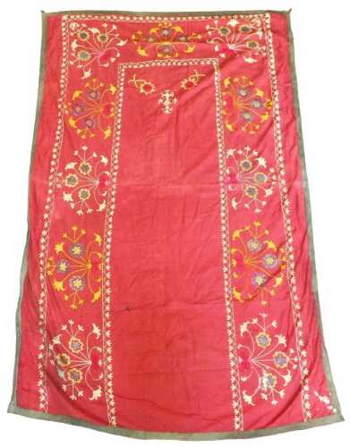 An Eastern Suzani tablecloth, with border embroidered with white, green, yellow, navy, gold...