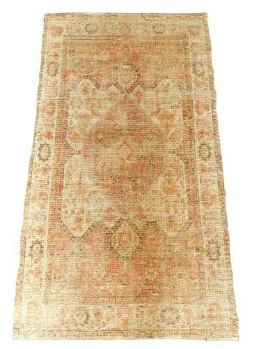 A modern Eastern style rug, decorated with central medallion, in red, on a cream ground, one...