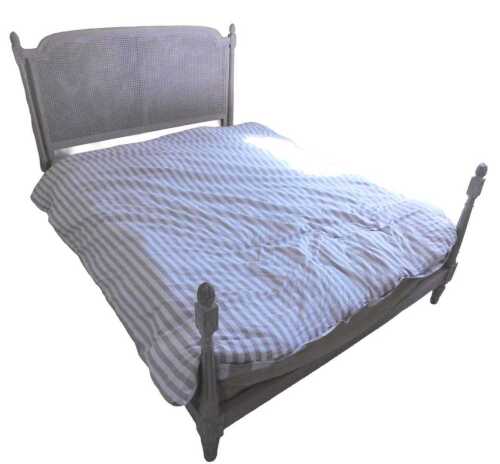 A French cream painted bed, the caned headboard with a moulded border, on fluted supports...