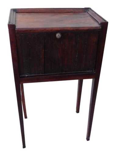 A Continental walnut bedside cabinet, the rectangular top with a raised border, above a fall...