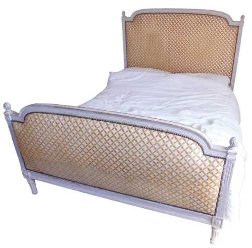 A French grey painted bed, with padded headboard and foot, each with a moulded frame, orb...