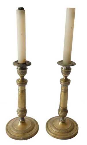 A pair of 19thC French silvered brass candlesticks, each with fine decorated bands of acanthus,...