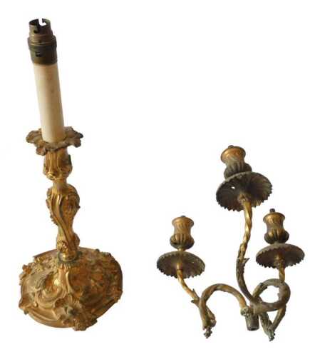 A 19thC French gilt metal candlestick, decorated in rococo style with scrolls, shells, etc.,...