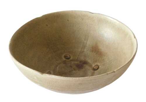 A Chinese celadon glazed bowl, the interior divided up into compartments, 16cm diameter. Offsite...