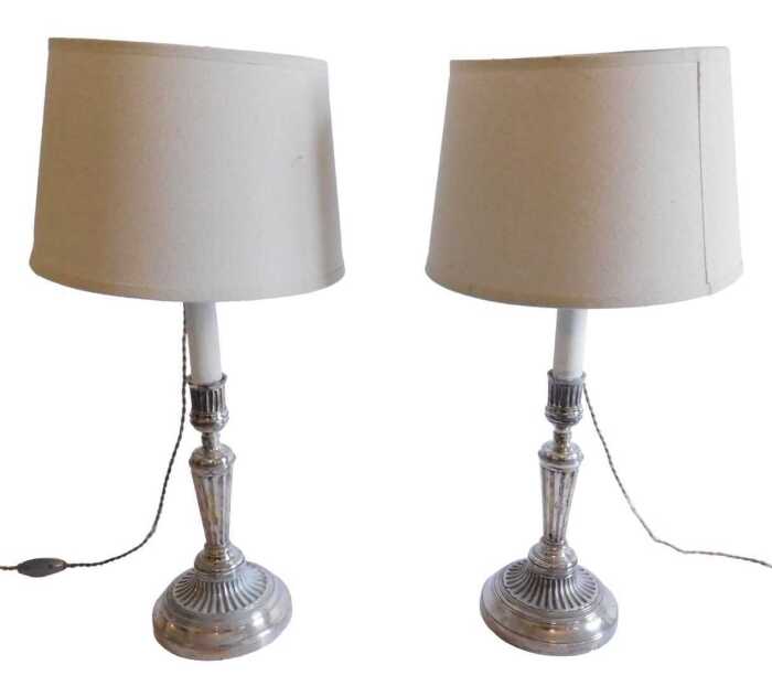 A pair of 19thC plated candlesticks, each of classical design, on tapering reeded column, and...
