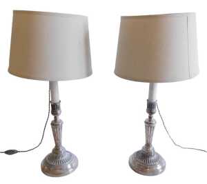 A pair of 19thC plated candlesticks, each of classical design, on tapering reeded column, and...
