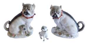 A pair of Continental Meissen style porcelain pug dogs groups, the first with standing dog and...