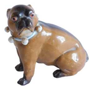 A very early 20thC Meissen porcelain figure of a standing pug dog, with orange eyes and blue and...