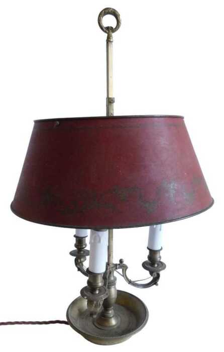 A French gilt brass three branch candelabrum, with acanthus leaf scroll arms, on a baluster stem...