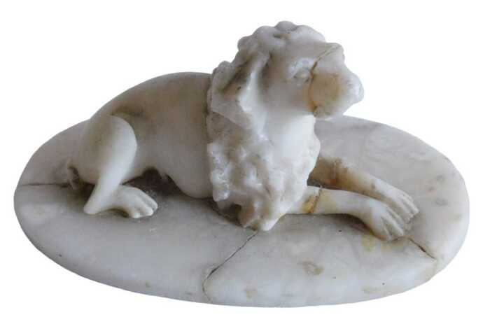 A 19thC marble Grand Tour style marble figure of a seated dog, on oval base, 9cm high. (AF)...