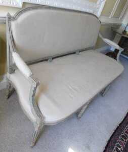 A 19thC painted French settee, with shaped oval back, with heavily carved acanthus leaf finials,... - 2