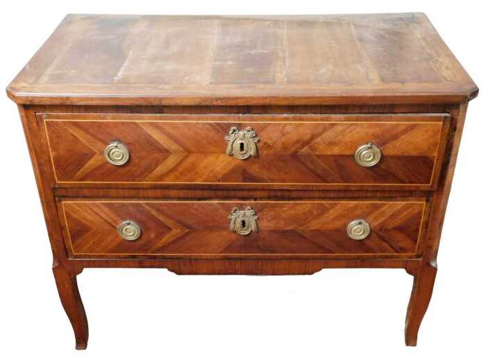 An 18thC walnut Louis XVI commode, the rectangular top with canted corners, above two chevron...