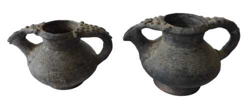 A Continental black glazed terracotta jug, the border and handle decorated with roundels, 15cm...