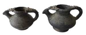 A Continental black glazed terracotta jug, the border and handle decorated with roundels, 15cm...