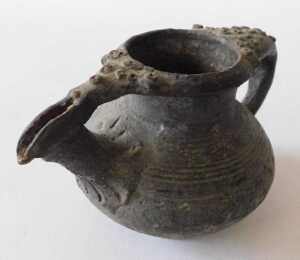 A Continental black glazed terracotta jug, the border and handle decorated with roundels, 15cm... - 2