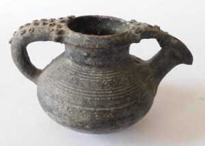 A Continental black glazed terracotta jug, the border and handle decorated with roundels, 15cm... - 3