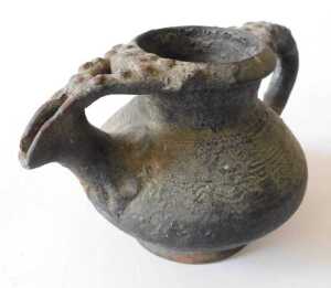 A Continental black glazed terracotta jug, the border and handle decorated with roundels, 15cm... - 5