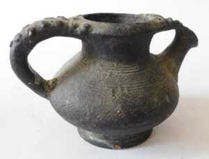 A Continental black glazed terracotta jug, the border and handle decorated with roundels, 15cm... - 7