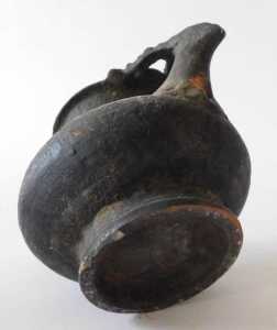 A Continental black glazed terracotta jug, the border and handle decorated with roundels, 15cm... - 8