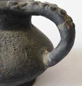 A Continental black glazed terracotta jug, the border and handle decorated with roundels, 15cm... - 9