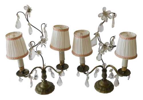A pair of French two branch candelabra, each with urn dish holders, on shaped feet, with cut...