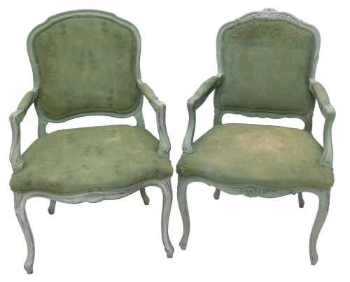 A pair of early 20thC painted French fauteuil, with shaped backs, carved arms, deep seats and...