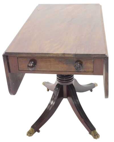 A Regency mahogany Pembroke table, the oblong top raised on turned support, terminating in...