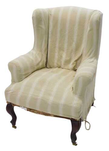 A 19thC mahogany wing armchair, with later striped green and cream material, on cabriole front...