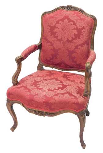 A 19thC French beech fauteuil, with shaped arms and cabriole legs, with carved floral patera,...