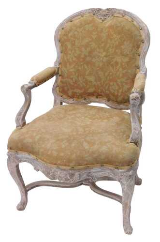 A 19thC limed oak chair, with shaped padded back, arms and deep seat, upholstered in petit point...