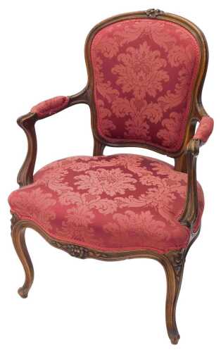 A 19thC walnut armchair, with shaped back with carved raised flower heads, above a shaped back,...