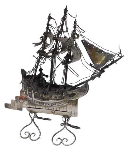A 19thC miniature model of a ship, with realistic decking, rigging, and articulated sails, on...