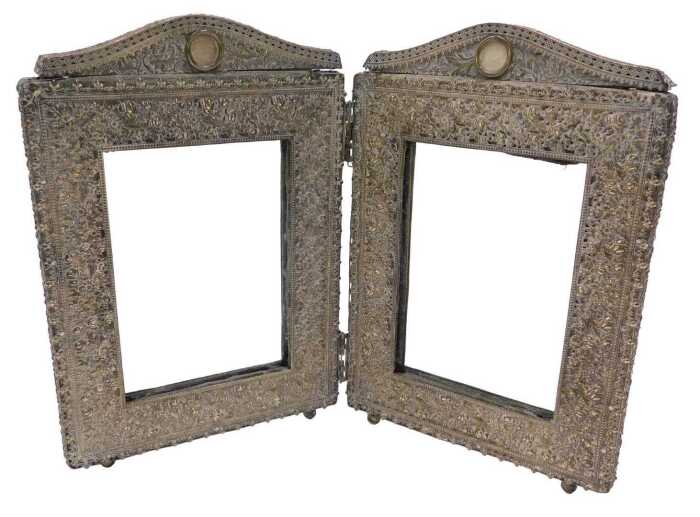 A 20thC two fold photograph frame, hinging at the centre, each section of rectangular form with...