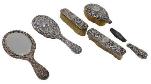 A Victorian harlequin silver five piece dressing table set, to include hairbrush repousse...