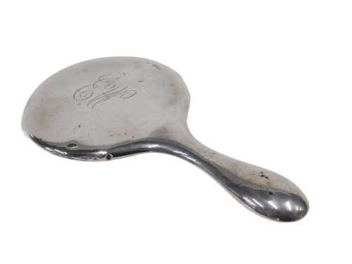 A George V silver hand mirror, with circular bevelled glass, shaped handle, initialled,...