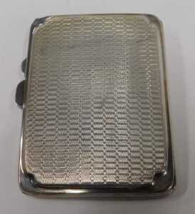 A George V silver cigarette or card case, of oblong form, with engine turned body and silver... - 2