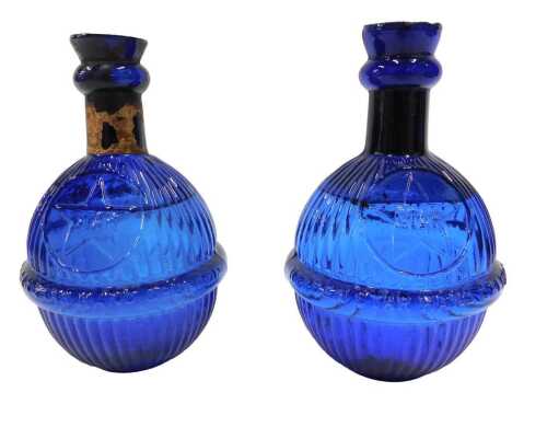 Two cobalt blue glass Harden's Star hand grenade fire extinguishers, each with textured bodies...