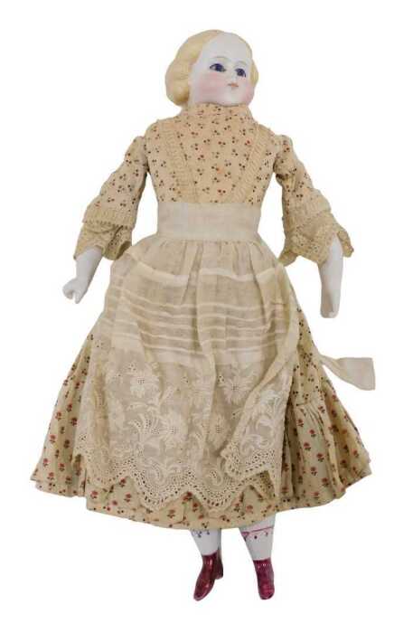 A 19thC bisque headed doll, with moulded hair, fixed eyes, closed mouth and with semi-porcelain...