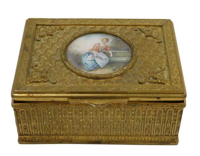 A 20thC gilt metal trinket box, of rectangular form, the hinged lid hand painted with a figure...