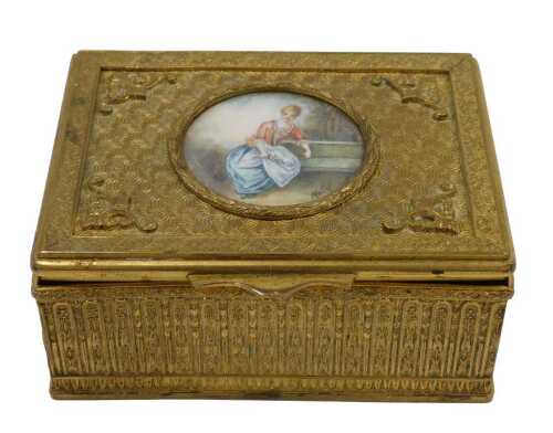A 20thC gilt metal trinket box, of rectangular form, the hinged lid hand painted with a figure...