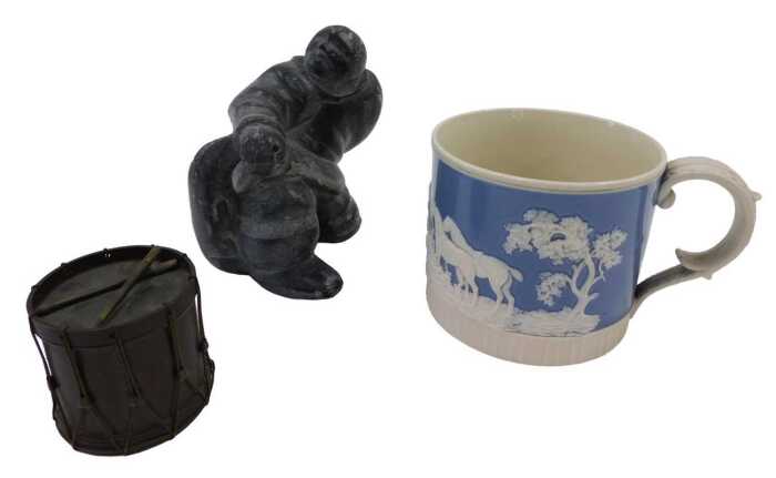 An Inuit carving, of a gentleman seated, unsigned, a 19thC Staffordshire pottery mug, raised...