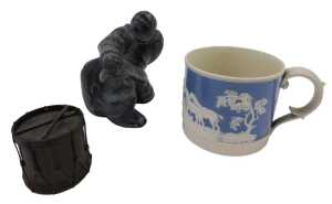 An Inuit carving, of a gentleman seated, unsigned, a 19thC Staffordshire pottery mug, raised...
