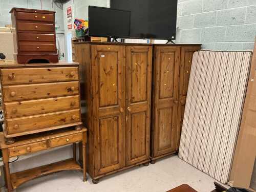V - A pine bedroom suite, comprising two double door wardrobes, chest of four long drawers, side...