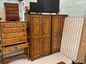 V - A pine bedroom suite, comprising two double door wardrobes, chest of four long drawers, side...