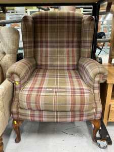 An oak wing chair, in chequered material.