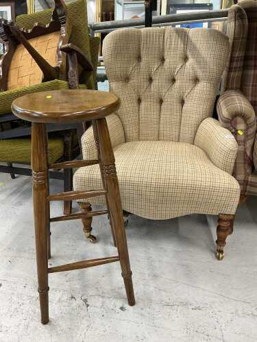 An oak framed open chair, with button back, upholstered in chequered material, on baluster...