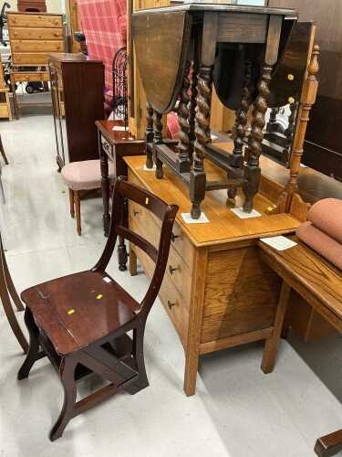 A late 20thC hardwood metamorphic library chair, and an oak barley twist table, and a light oak...